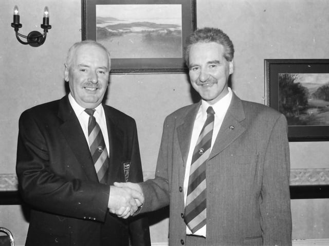 Colm O’Kane, outgoing captain at Ballyliffin Golf Club, congratulates the new captain, Hugo Boyce, at the club’s annual dinner which was held in the Strand Hotel.