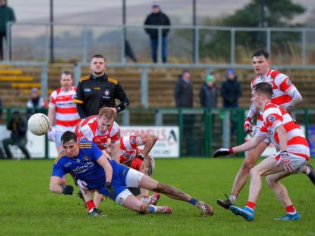 Steelstown’s Jason McAlerr is chased by a pack of Moortown players in Owenbeg on Sunday afternoon last.