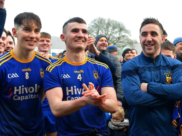 Steelstown’s Oran McMenamin, Dairmuid Baker and Ryan Devine watch on as Neil Forester lifts the cup.