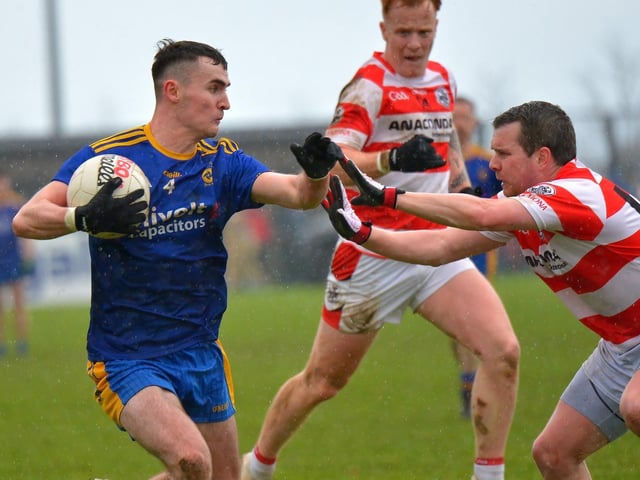Steelstown’s Diarmuid Baker fends off a tackle from Moortown’s Paudraic O’Hagan at Owenbeg
