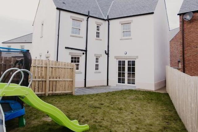 The private rear garden has a lawn and patio.