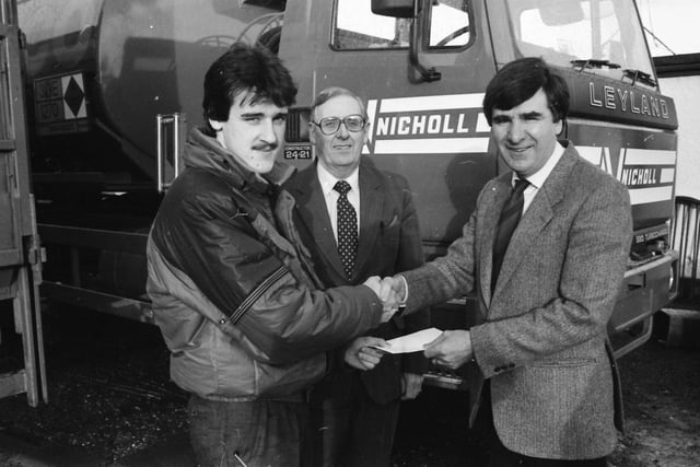 Mr. Gary Nicholl, sales manager, Nicholl Fuel Oils. Ltd., Greysteel, presents a cheque for sponsorship of Derry City F.C. against Shamrock Rovers at Brandywell to Mr. Jim McLaughlin, manager, Derry City F.C. Centre is Mr. Jack Breslin, sales representative.