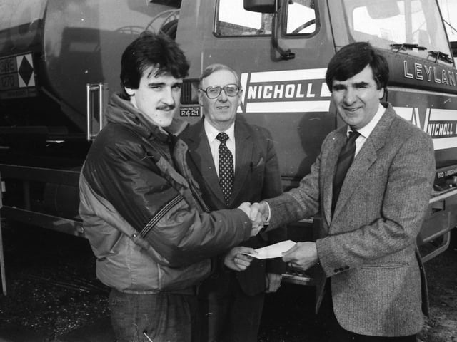Mr. Gary Nicholl, sales manager, Nicholl Fuel Oils. Ltd., Greysteel, presents a cheque for sponsorship of Derry City F.C. against Shamrock Rovers at Brandywell to Mr. Jim McLaughlin, manager, Derry City F.C. Centre is Mr. Jack Breslin, sales representative.