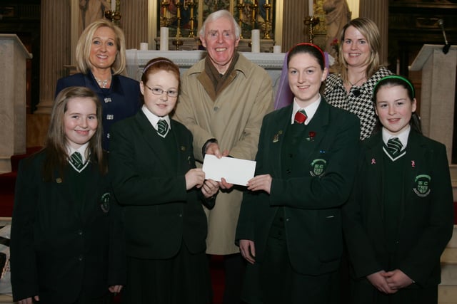 St.Cecilia's College pupils Sarah Gillespie, Niamh McQuaid, Erin Kivlehan and Ceara Kivlehan, presenting a cheque, proceeds of the schools' annual carol service held in St. Columb's Church, Long Tower, to Brian Sharkey, St. Vincent de Paul. Included are Mrs. Kathleen Gormley, principal, and Ms. Clare Mullan, SVdP co-ordinator, St. Cecilia's College. (0202C28)
