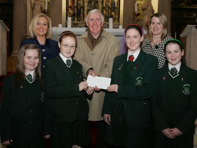St.Cecilia's College pupils Sarah Gillespie, Niamh McQuaid, Erin Kivlehan and Ceara Kivlehan, presenting a cheque, proceeds of the schools' annual carol service held in St. Columb's Church, Long Tower, to Brian Sharkey, St. Vincent de Paul. Included are Mrs. Kathleen Gormley, principal, and Ms. Clare Mullan, SVdP co-ordinator, St. Cecilia's College. (0202C28)