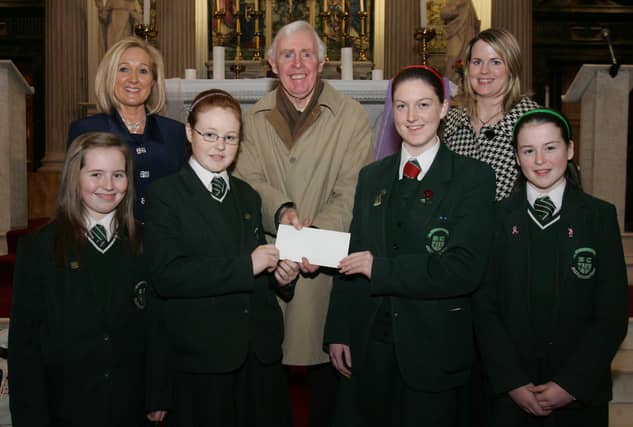 St. Cecilia's College students Sarah Gillespie, Niamh McQuaid, Erin Kivlehan and Ceara Kivelehan, presenting a cheque, proceeds of the schools' annual carol service in St. Columb's Church, Long Tower, to Brian Sharkey, St. Vincent de Paul. Included are Mrs. Kathleen Gormley, principal, and Ms. Clare Mullan, SVdP co-ordinator, St. Cecilia's College. (0201C18)