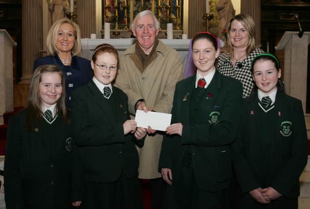 St. Cecilia's College students Sarah Gillespie, Niamh McQuaid, Erin Kivlehan and Ceara Kivelehan, presenting a cheque, proceeds of the schools' annual carol service in St. Columb's Church, Long Tower, to Brian Sharkey, St. Vincent de Paul. Included are Mrs. Kathleen Gormley, principal, and Ms. Clare Mullan, SVdP co-ordinator, St. Cecilia's College. (0201C18)
