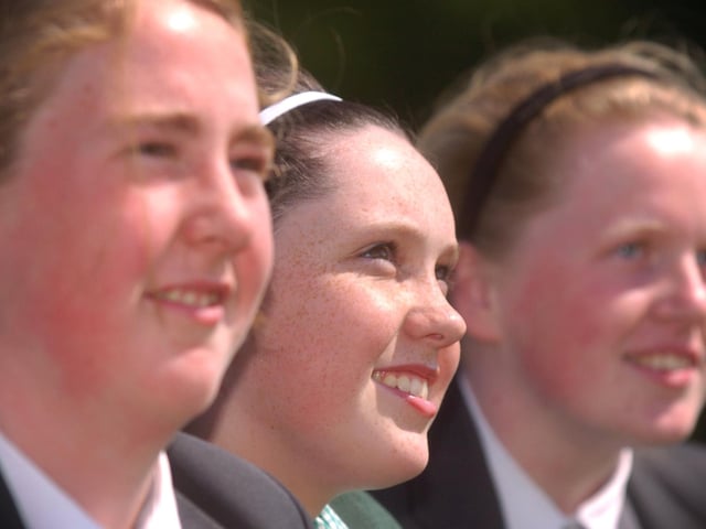 St Cecilia's College pupils Gillian Herron, Aine Rankin and Jennifer Herron enjoy a spot of sunbathing after school yesterday as term time comes to an end. (2706PG18)
