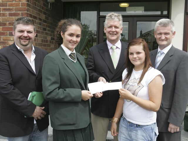 Kevin McDowell, district manager, Housing Executive, presenting awards to St. Cecilia's college Year 11 students Ciara Hone and Lindsay Preston, who participated in the Housing Executive Programme on Housing, Homelessness and Community Safety. Included are Gareth Ferguson, NIHE, and Ward Devine, vice-principal. (3006C40)