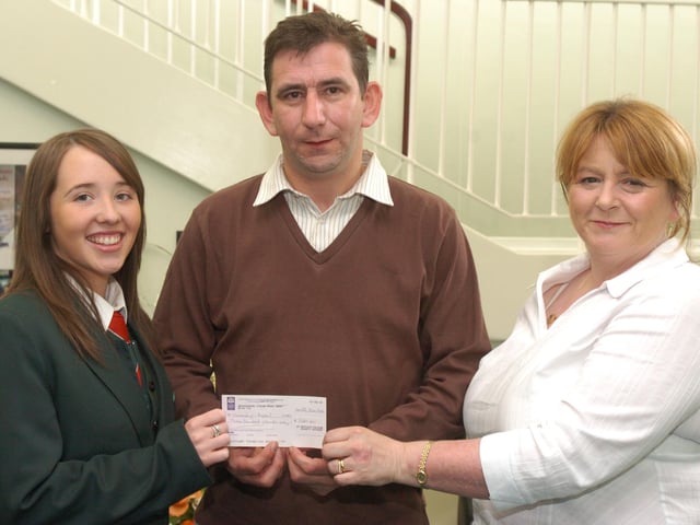 Joanna Roberts, left, and Briege Lewis from St Cecilias College present Paul Carlisle, Chernbobyl Childrens Project, with a cheque for £300, money raised by the sale of ribbons in the school. (2706PG30)