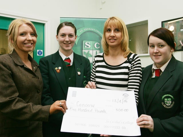 St. Cecilia's College students Martina McGrath, Erin Kivelhan and Bronagh Coll presenting a cheque to Sharon Bergin who received it on behalf of Concern, Derry.  (1404Jb44)