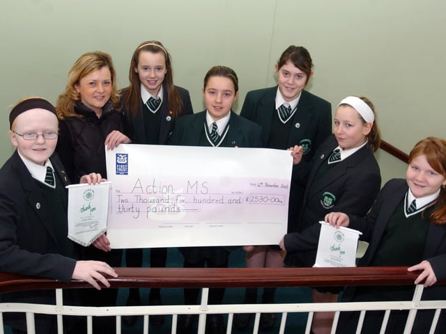 Year 8 pupil, St Cecilia's College, presenting a cheque, for £2,530, to Caroline Stewart, MS Action, the proceeds of a sponsored walk at Roe Valley Country Park. Included, are Lauren Friel. Katie McClucas, Carrie lee Duffy, Rachel healy, Lauren McLoughlin, Jenna Gibbon. (2701A24)
