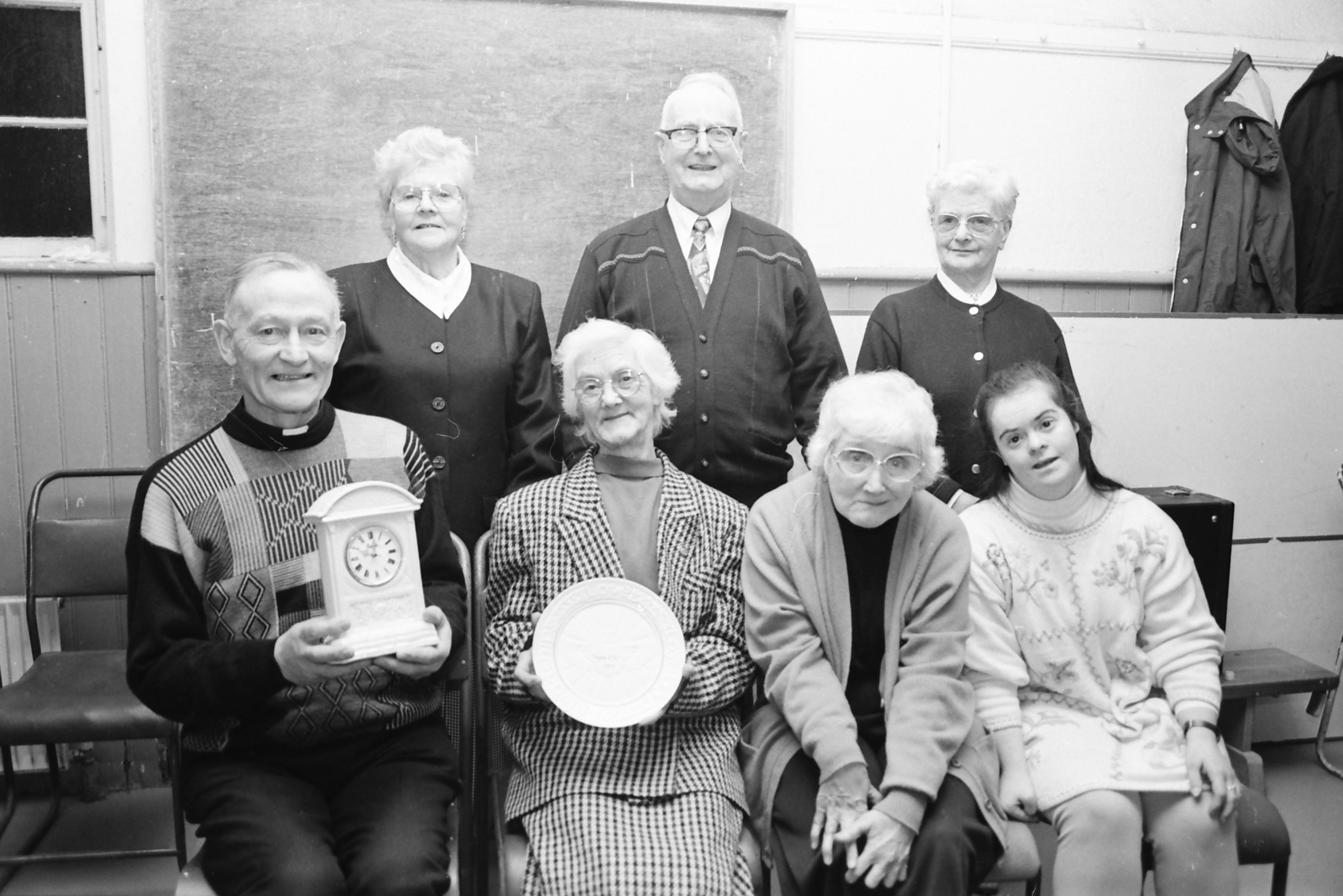 Father James McGlinchey, C.C., Desertegney, seated left, presenting gifts on behalf of the parish, to Tessie and Róis McLaughlin, seated second and third from left, on their retirement from Linsfort Post Office after more than sixty years of service to the community. They followed in the footsteps of their late father James McLaughlin, who opened the Post Office in 1927. Included are family members Bridie McLaughlin, Paddy McLaughlin, Bridget McLaughlin and Patricia McLaughlin.
