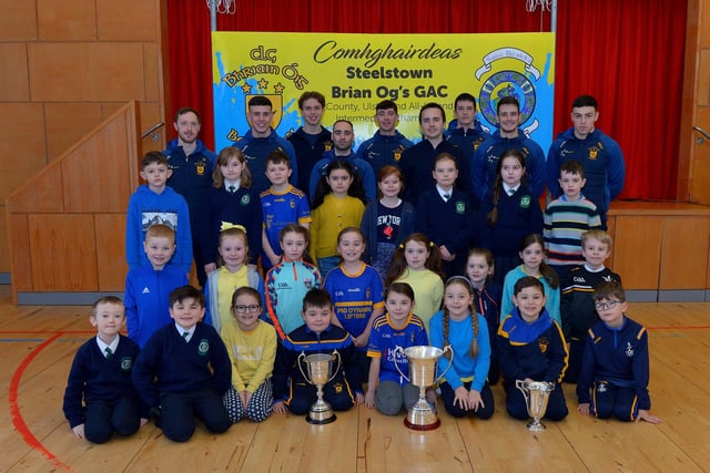 St Patrick’s PS Pennyburn P4 pupils pictured with Steelstown Brian Og’s players Neil Forester, captain, Morgan Murray, Donncha Gilmore, Garth Logue, Jason McAleer, Ciarán Flanaghan, Eoghan Heraghty, Dermot McBride, coach, and Ben McCarron on Friday morning last. Photo: George Sweeney.  DER2208GS – 076