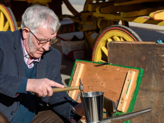 Tinsmith Tom McDonald demonstrates crafting.