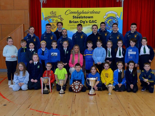 St Patrick’s PS Pennyburn P4 pupils pictured with Steelstown Brian Og’s players Neil Forester, captain, Morgan Murray, Donncha Gilmore, Garth Logue, Jason McAleer, Ciarán Flanaghan, Eoghan Heraghty, Dermot McBride, coach, Ben McCarron and Ella-Rose Sainsbury, ladies team, on Friday morning last. Photo: George Sweeney. DER2208GS – 078