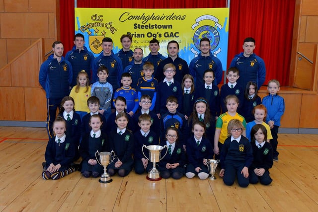 St Patrick’s PS Pennyburn P4 pupils pictured with Steelstown Brian Og’s players Neil Forester, captain, Eoghan Heraghty, Morgan Murray, Donncha Gilmore, Garth Logue, Jason McAleer, Ciaran Flanaghan, Dermot McBride, coach, and Ben McCarron on Friday morning last. Photo: George Sweeney.  DER2208GS – 075