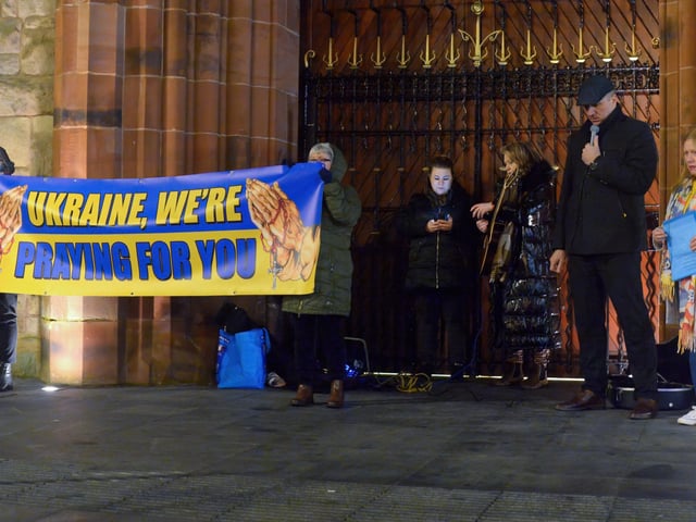 Organisers of the candle-lit vigil in solidarity with the people of Ukraine with Fr Ignaacy Saniuta at Guildhall Square on Wednesday evening last. Photo: George Sweeney. DER2209GS – 030