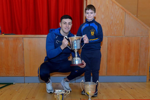 St Patrick’s PS Pennyburn P4 pupil Harry McCarron  pictured with his cousin Steelstown and Derry county player Ben McCarron during a visit by Brian Og’s to the school on Friday morning last. Photo: George Sweeney.  DER2208GS – 079