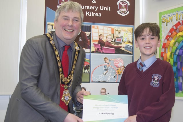 The Mayor of Causeway Coast and Glens Borough Council Councillor Richard Holmes presents a certificate to Jack Brolly Quigg who took part in the Energy Innovation Challenge