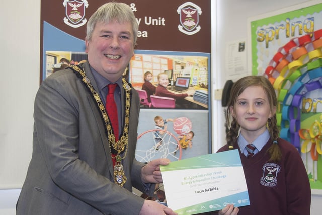 The Mayor of Causeway Coast and Glens Borough Council Councillor Richard Holmes presents a certificate to Lucia McBride who took part in the Energy Innovation Challenge