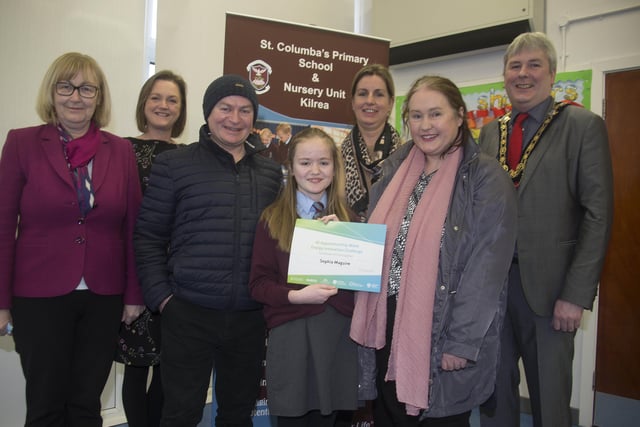 The Mayor of Causeway Coast and Glens Borough Council Councillor Richard Holmes pictured with Energy Innovation Challenge winner Sophia Maguire, her parents Caroline & Kevin and members of staff from St Columba’s Primary School in Kilrea L-R Principal Mrs Celine Kielt, and teachers Mrs Geraldine Martin & Miss Sue-Anne McKiernan