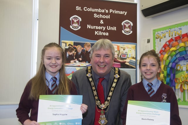 The Mayor of Causeway Coast and Glens Borough Council Councillor Richard Holmes presents a certificate to Sophia Maguire and Devin Putney