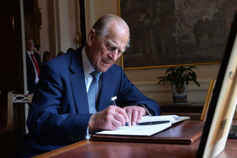 Prince Philip, Duke of Edinburgh signs the visitors book at Hillsborough castle as they leave for their final engagement in Coleraine on June 25, 2014 in Belfast, Northern Ireland. The Royal party are visiting Northern Ireland for three days.