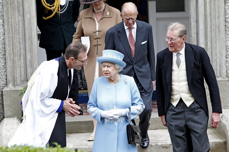 Queen Elizabeth II and the Duke of Edinburgh leave St. Macartin's Cathedral in Enniskillen, County Fermanagh, accompanied by Dean Kenneth Hall (left) and Lord Anthony Hamilton (right) during a two-day visit to Northern Ireland as part of the Diamond Jubilee tour.