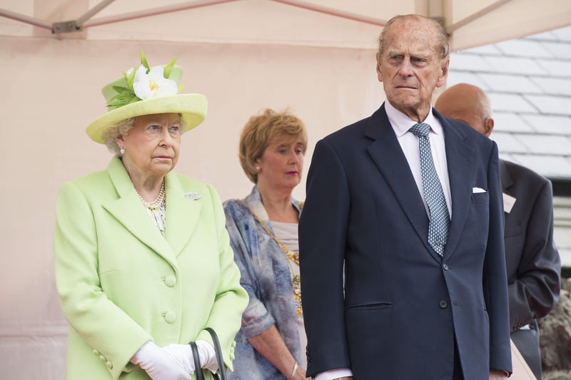Queen Elizabeth II and the Duke of Edinburgh during a visit to Bushmills Village, where she is unveiling a statue of Robert Quigg, VC, during the second day of her visit to Northern Ireland to mark her 90th birthday.