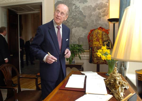 His Royal Highness, The Duke of Edinburgh signs the visitors book after meeting recipients and guests of the Duke of Edinburgh Award Scheme  at a special reception at Hillsborough Castle as they recieved their Gold Awards. Picture Charles McQuillan/Pacemaker.