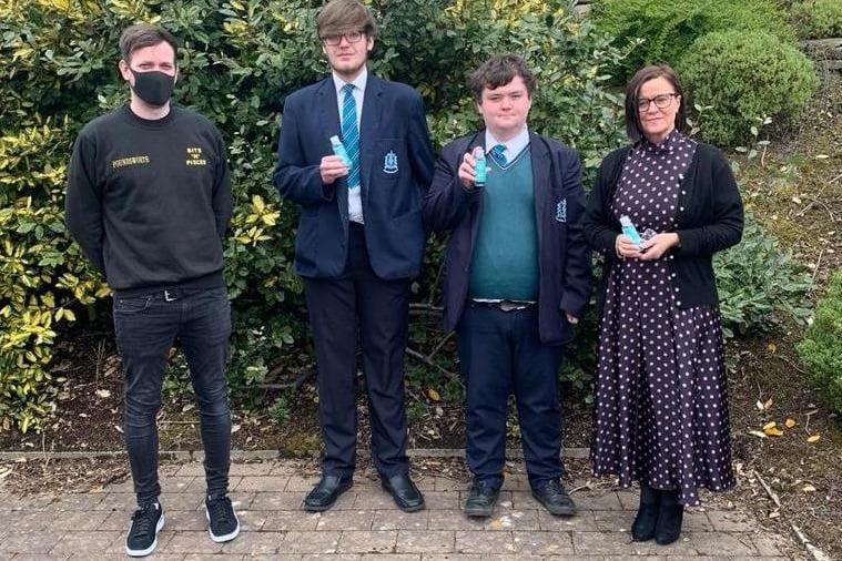 Representatives from St. Patrick’s and St. Brigid’s, Claudy, pictured receiving a total of  1,000 bottles of hand sanitiser from Mr. O’Carroll on Monday.