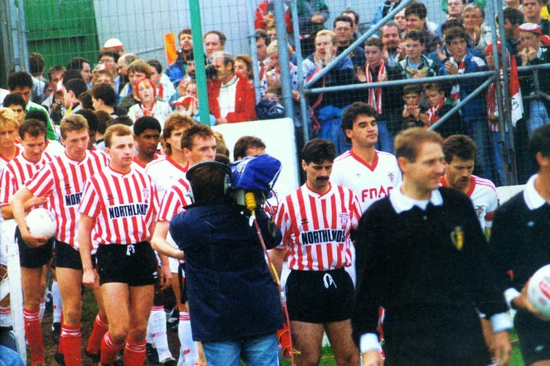 Derry City captain Felix Healy and Benfica skipper António Augusto da Silva Veloso lead the players out onto the Brandywell ahead of their 1989 European Cup tie.