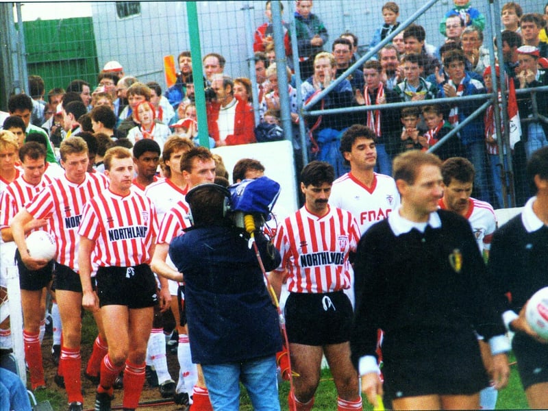 Derry City captain Felix Healy and Benfica skipper António Augusto da Silva Veloso lead the players out onto the Brandywell ahead of their 1989 European Cup tie.