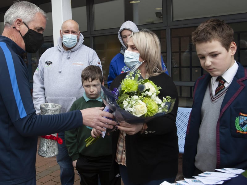 Mr Colin Donaghey (Year Head) presenting Jacqueline Gurney with a bouquet of flowers with reflections and messages attached during Monday's event at the school to remember her late son Lee. (Photos: Jim McCafferty Photography)