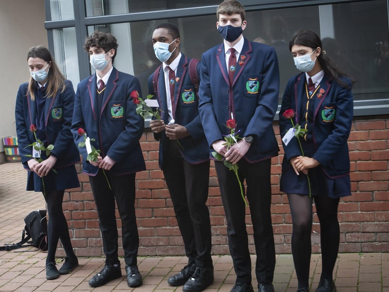 Friends Eva Wright, Sam Cole, Aajon Tench pictured during Monday's tribute, with Head Boy Conor Brattin and Head Girl Emily Brown.