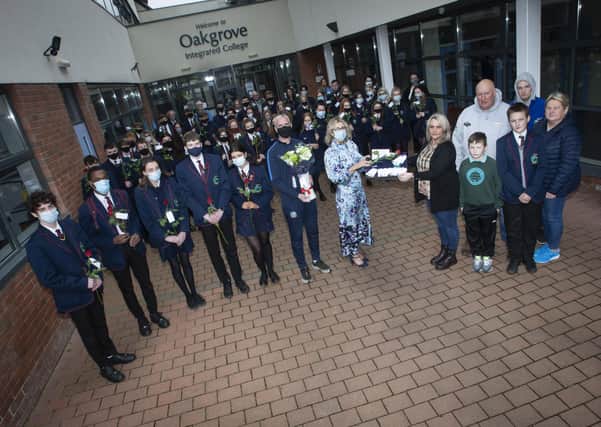Mrs Katrina Crilly (Principal) presenting Leeâ€TMs mum Jacqueline Gurney with Lee's Oakgrove Leavers Hoodie at Oakgrove Integrated College on Monday. Included are sixth form students and members of staff. On right also are Lee's dad Derek, brothers Jay and Cain, and family friend Melanie Toland. (Photos: Jim McCafferty Photography)