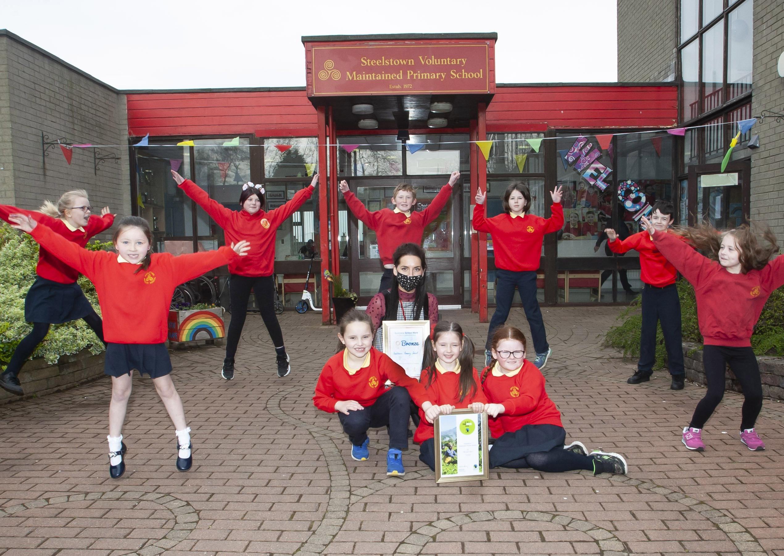 Miss Bronagh Lynch pictured with some of the pupils from Steelstown PS celebrate their achievement in the FairAware School awards this week. Kneeling, front centre are Aoife Lynch, Niah Barnfield and Maya O'Doherty. Standing from left are Hannah O'Neill, Niaya McCafferty, Ava McGill, Andrew O'Doherty, Lola Foy (Eco Committee President), Braeden Rush (Eco Committee Vice President) and Elsa Kehoe.