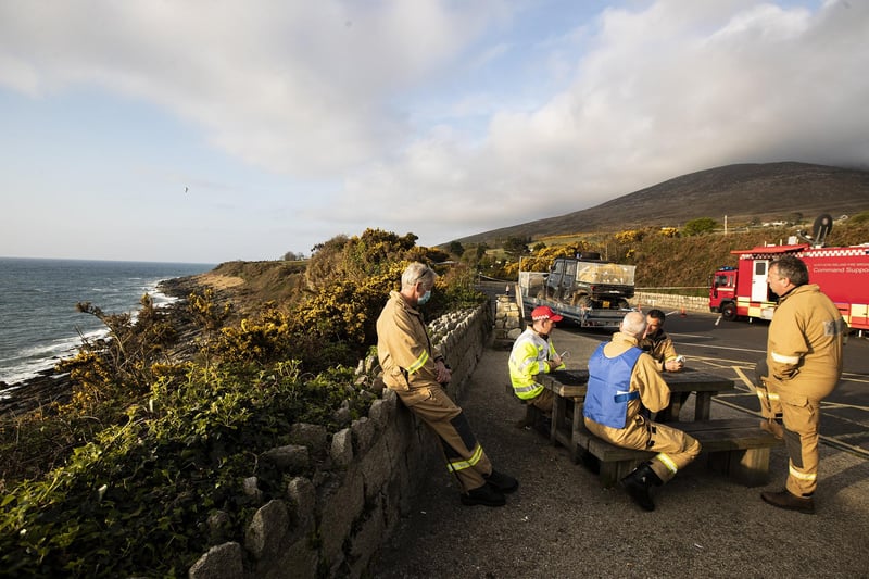 PACEMAKER BELFAST  25/04/2021
Fire Officers conduct a briefing at the Bloody Bridge just outside Newcastle at the control point of a major wildfire in the Mourne Mountains that is now into its 3rd day. Credit: Conor Kinahan/Pacemaker Press