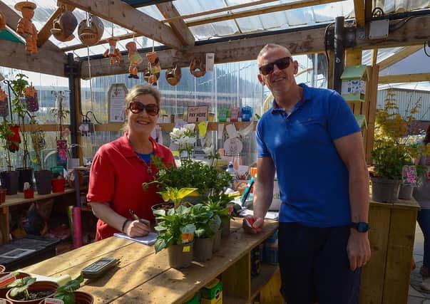 Leona Kelly serves customer John Fox at the Springrowth Landscape and Garden Centre, Springtown Industrial Estate. DER2115GS – 024