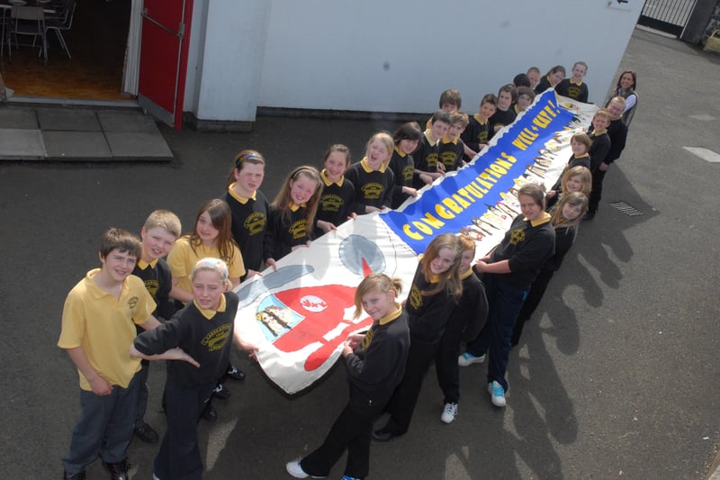 Mrs Black and the P7 class at Larne and Inver Primary School with the Royal wedding banner they made in 2011. INLT 16-372-PR
