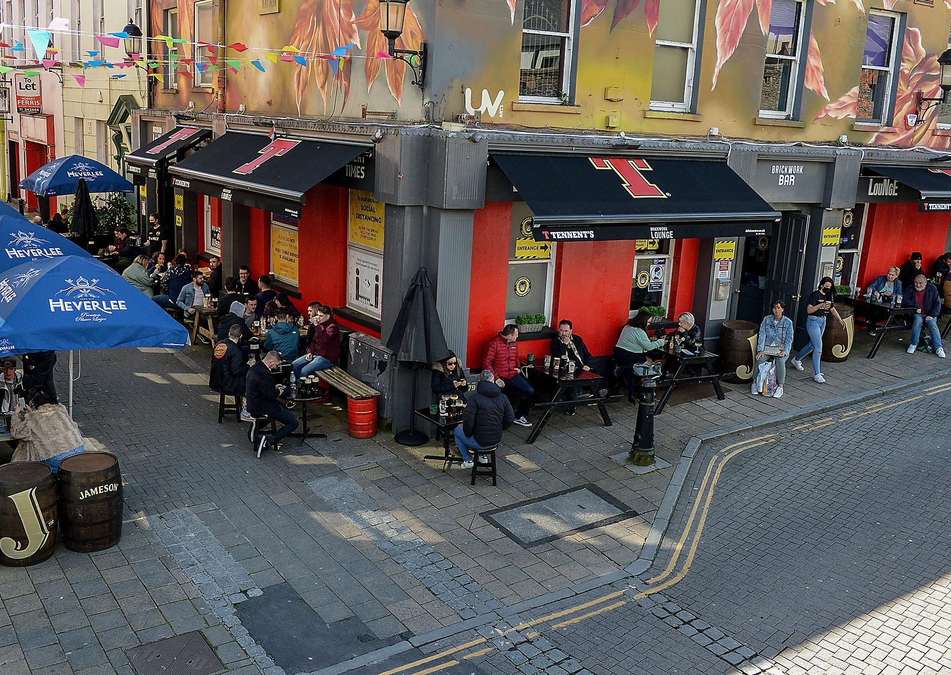 Customers enjoy the sunshine and a drink over the Bank Holiday weekend as lockdown restrictions were further eased on Friday last. Photo: George Sweeney / Derry Journal.  DER2117GS - 052