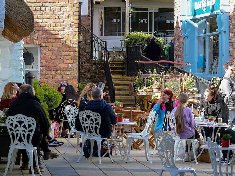 People relax in the Craft Village on Friday morning as cafes reopened. Photo: George Sweeney / Derry Journal. DER2117GS 045
