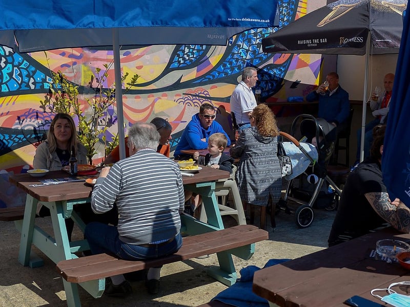Customers enjoy lunch in the sunshine as pubs with outdoor service reopened on Friday last. Photo: George Sweeney / Derry Journal. DER2117GS - 047