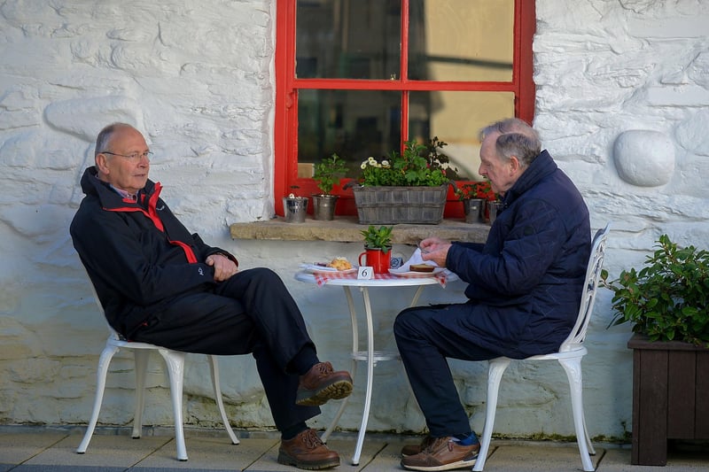 Far from the Madding Crowd, these gentlemen enjoy a coffee, in the Craft Village on Friday morning as cafes reopened. Photo: George Sweeney / Derry Journal.  DER2117GS - 044