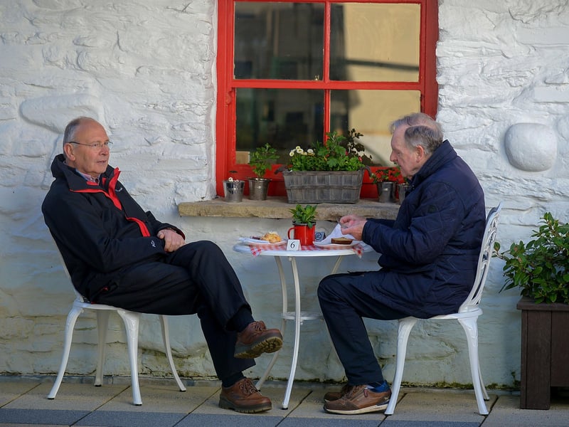 Far from the Madding Crowd, these gentlemen enjoy a coffee, in the Craft Village on Friday morning as cafes reopened. Photo: George Sweeney / Derry Journal. DER2117GS - 044