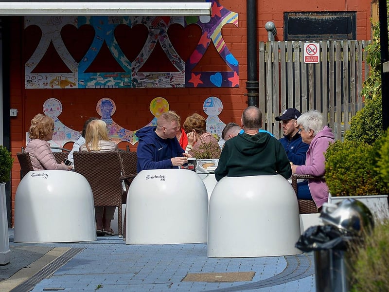 Customers enjoy a coffee, outside the Sandwich Company, on Friday morning last after latest easing of lockdown restrictions. DER2116GS - 032