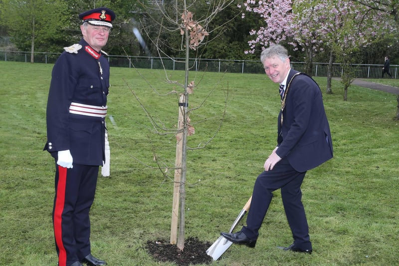The Mayor of Causeway Coast and Glens Borough Council Alderman Mark Fielding plants a native oak tree at Riverside Park in Ballymoney along with the Lord-Lieutenant for County Antrim Mr David McCorkell