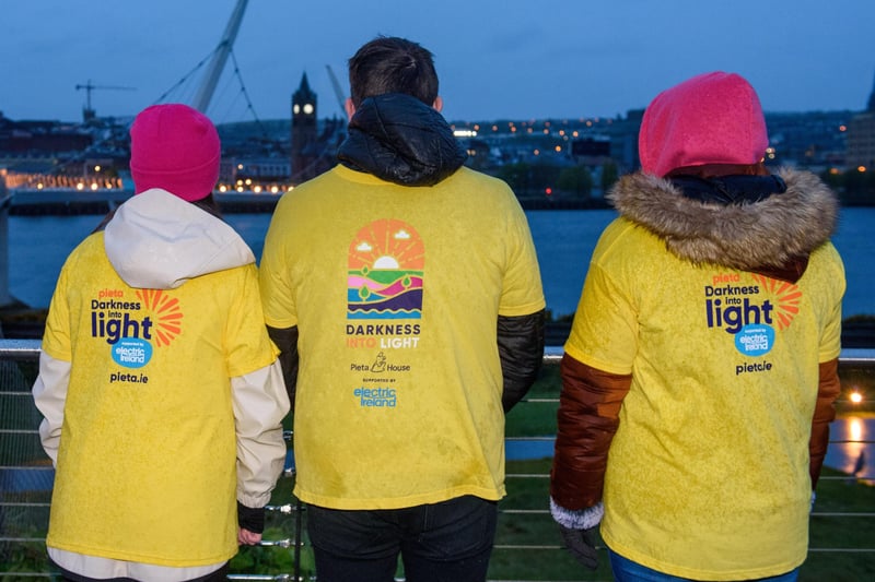 Sarah Louise Temple, Fiona Temple and Jason Earley, pictured at the Peace Bridge in Derry during the Pieta Darkness Into Light 2021 sunrise walk supported by Electric Ireland.