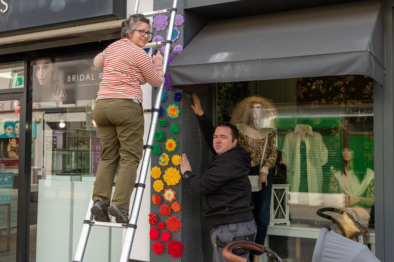 Alana and Steven Durrant installing a bouquet of crocheted flowers at Seven on Market Street.